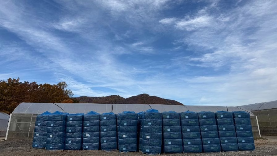 Palletized substrate stored off the ground and wrapped to protect against moisture. Proper storage preserves physical properties and supports consistency when planting begins weeks later.