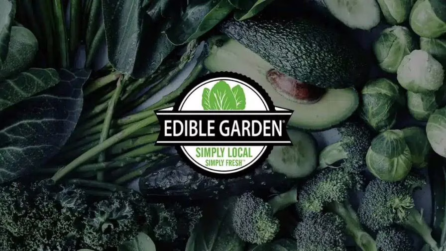 Edible Garden logo atop greenhouse and CEA produce and vegetables.